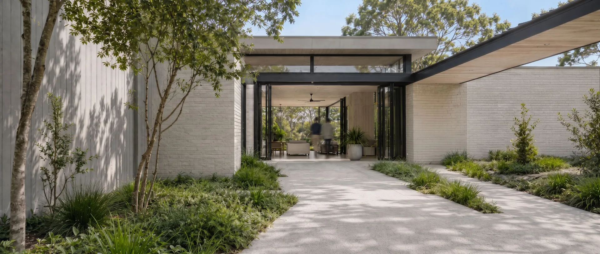 Contemporary landscaped residential entry with two motion-blurred people